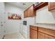 Laundry room features wood cabinets and granite countertops at 17535 E Silver Sage Ln, Rio Verde, AZ 85263