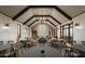 Large community room with high ceilings, chandelier, and multiple tables at 1932 W Rowel Rd, Phoenix, AZ 85085