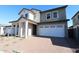 Charming two-story home featuring a two-car garage and a welcoming covered entryway with substantial pillars at 1932 W Rowel Rd, Phoenix, AZ 85085