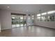 Bright living room with wood floors, large windows, and sliding glass doors leading to backyard at 1932 W Rowel Rd, Phoenix, AZ 85085