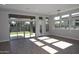 Bright and airy living room with hardwood floors, many windows providing natural light, and a sliding door to the outside at 1932 W Rowel Rd, Phoenix, AZ 85085