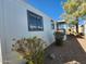 View of home's side with mature shrubs and gravel at 2233 E Behrend Dr # 93, Phoenix, AZ 85024