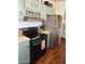 Stainless steel appliances and light green cabinets in this kitchen at 2233 E Behrend Dr # 93, Phoenix, AZ 85024