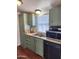 Stainless steel appliances and green cabinets in this kitchen at 2233 E Behrend Dr # 93, Phoenix, AZ 85024
