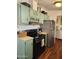 Kitchen boasts stainless steel appliances and light green cabinets at 2233 E Behrend Dr # 93, Phoenix, AZ 85024