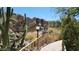 Stone pathway alongside a scenic waterfall feature in a desert landscape at 2233 E Behrend Dr # 93, Phoenix, AZ 85024