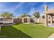 Artificial turf backyard with gazebo and outdoor kitchen at 224 S 151St Ave, Goodyear, AZ 85338