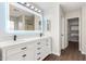 Bathroom with double vanity, white cabinets, and a large mirror at 224 S 151St Ave, Goodyear, AZ 85338