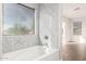 Modern bathroom features a soaking tub and stylish tile at 224 S 151St Ave, Goodyear, AZ 85338