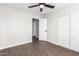 Bright bedroom with wood-look floors, ceiling fan and double closets at 224 S 151St Ave, Goodyear, AZ 85338