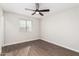 Bedroom with wood-look floors, ceiling fan and window blinds at 224 S 151St Ave, Goodyear, AZ 85338
