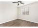 Bright bedroom with wood-look floors, ceiling fan, and window blinds at 224 S 151St Ave, Goodyear, AZ 85338