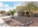 Tan two-story house with a stone facade, attached garage, and landscaped front yard at 224 S 151St Ave, Goodyear, AZ 85338