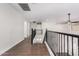 Upstairs hallway with wood floors and access to bedrooms at 224 S 151St Ave, Goodyear, AZ 85338