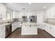Modern kitchen with white cabinets, granite countertops, and stainless steel appliances at 224 S 151St Ave, Goodyear, AZ 85338