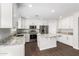 Modern kitchen with white cabinets, granite countertops, and stainless steel appliances at 224 S 151St Ave, Goodyear, AZ 85338