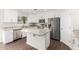 Modern kitchen with white cabinets, granite countertops, and a kitchen island at 224 S 151St Ave, Goodyear, AZ 85338
