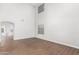 Open living room with hardwood floors and views into the kitchen and backyard at 224 S 151St Ave, Goodyear, AZ 85338