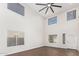 Bright living room with high ceilings, hardwood floors, and large windows at 224 S 151St Ave, Goodyear, AZ 85338
