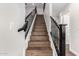 Modern staircase with black metal railings and wood steps at 224 S 151St Ave, Goodyear, AZ 85338