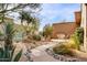 Landscaped courtyard with a winding path, desert plants, and a seating area at 28013 N Desierto Dr, Rio Verde, AZ 85263