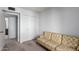 Small bedroom with double closet and patterned sofa at 3013 W Redfield Rd, Phoenix, AZ 85053