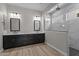 Elegant primary bathroom with double vanity, walk-in shower, and wood-look tile flooring at 32470 N 134Th Ln, Peoria, AZ 85383