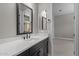 Modern bathroom featuring a sleek black vanity with a white countertop and matte black fixtures at 32470 N 134Th Ln, Peoria, AZ 85383