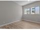 Bright bedroom featuring wood floors and large windows with an outdoor view at 32470 N 134Th Ln, Peoria, AZ 85383