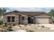 Single-story home with stone accents and a two-car garage at 32470 N 134Th Ln, Peoria, AZ 85383