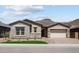 Inviting single-story home featuring stone accents, a tiled roof, and desert landscaping at 32470 N 134Th Ln, Peoria, AZ 85383