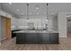 Open kitchen featuring an island with seating, modern pendant lights, and stainless appliances at 32470 N 134Th Ln, Peoria, AZ 85383