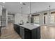 Stylish kitchen island with quartz countertop, stainless steel dishwasher, and modern pendant lighting at 32470 N 134Th Ln, Peoria, AZ 85383