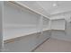 Spacious walk-in closet featuring built-in shelving, racks, and ample storage space at 32470 N 134Th Ln, Peoria, AZ 85383