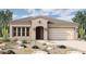 Single-story home with a two-car garage and desert landscaping at 33010 N 131St Dr, Peoria, AZ 85383