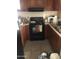 Small kitchen with appliances and dark brown cabinets at 3526 W Dunlap Ave # 172, Phoenix, AZ 85051