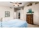 Charming bedroom with a ceiling fan, walk-in closet and dresser at 3913 E Tremaine Ave, Gilbert, AZ 85234