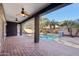 Relaxing covered patio overlooking a sparkling pool and lush landscaping at 4188 E Lexington Ave, Gilbert, AZ 85234