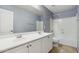 Bathroom with a double sink vanity, framed mirror, and a tub and shower combination at 4188 E Lexington Ave, Gilbert, AZ 85234