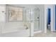 Bright bathroom features a large tub and glass-enclosed shower at 4188 E Lexington Ave, Gilbert, AZ 85234