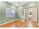 Bedroom with wood floors, a ceiling fan, and a view into the attached bathroom at 4188 E Lexington Ave, Gilbert, AZ 85234