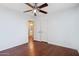Bedroom with wood laminate flooring, a ceiling fan, and a mirrored closet at 4188 E Lexington Ave, Gilbert, AZ 85234