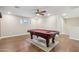A game room with a billiard table sits on a rug and hardwood flooring at 4188 E Lexington Ave, Gilbert, AZ 85234