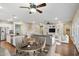 Inviting open-concept living space featuring hardwood floors and built-in shelving for storage and display at 4188 E Lexington Ave, Gilbert, AZ 85234