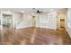 Spacious living room features hardwood floors, a staircase, a ceiling fan, and a built-in shelving unit at 4188 E Lexington Ave, Gilbert, AZ 85234