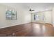 Bright living room with hardwood floors, a ceiling fan, and large windows offering plenty of natural light at 4188 E Lexington Ave, Gilbert, AZ 85234