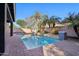 Backyard pool with brick coping and block fencing, surrounded by lush palm trees at 4188 E Lexington Ave, Gilbert, AZ 85234