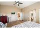 Main bedroom with a dresser, a TV, and access to the bathroom at 45513 W Sky Ln, Maricopa, AZ 85139