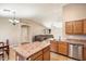 Open kitchen with island and stainless steel appliances, overlooking living room at 45513 W Sky Ln, Maricopa, AZ 85139