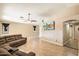 Bright living room, tile floors, and a large flat-screen TV at 45513 W Sky Ln, Maricopa, AZ 85139
